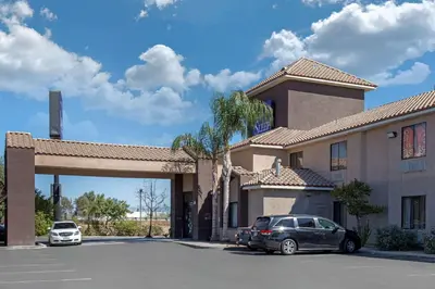 a car parked in a parking lot in front of a hotel at Sleep Inn & Suites Bakersfield North in Bakersfield