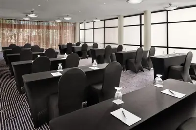 a conference room with black tables and chairs at Sheraton Ontario Airport Hotel in Ontario