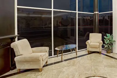 two chairs and a table in front of a window at Super 8 by Wyndham Cypress Buena Park Area in Cypress