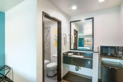 a bathroom with a sink and a toilet and a mirror at Motel 6-South El Monte, CA - Los Angeles in South El Monte