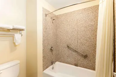 a bathroom with a shower and a toilet at Travelodge by Wyndham Brea in Brea