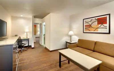 a living room with a couch and a table at Cortona Inn and Suites Anaheim Resort in Anaheim