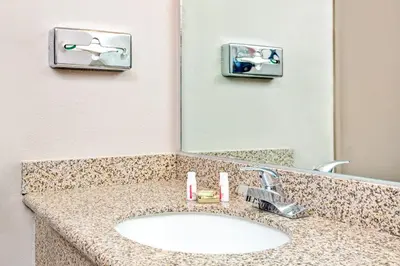 a bathroom counter with a sink and a mirror at Super 8 by Wyndham Upland Ontario CA in Upland