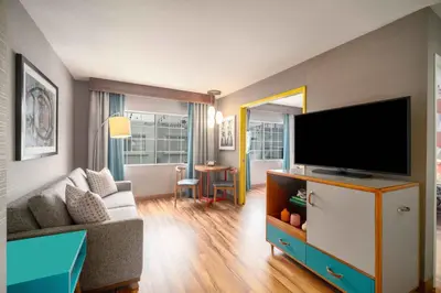 a living room with a couch and a tv at The Kinney - Venice Beach in Los Angeles