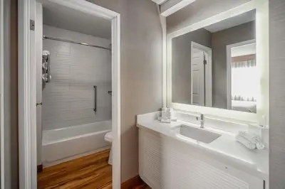 a bathroom with a sink and a tub and a toilet at The Kinney - Venice Beach in Los Angeles