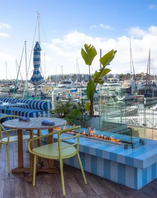 a patio with a table and chairs and a fire place at Marina del Rey Hotel in Los Angeles