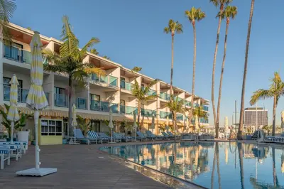 a hotel with palm trees and a swimming pool at Marina del Rey Hotel in Los Angeles