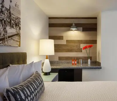 a bedroom with a bed and a table with a lamp at Inn at Venice Beach in Los Angeles