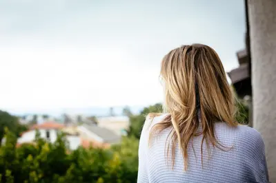 a woman looking out of a window at a city at Inn at Venice Beach in Los Angeles