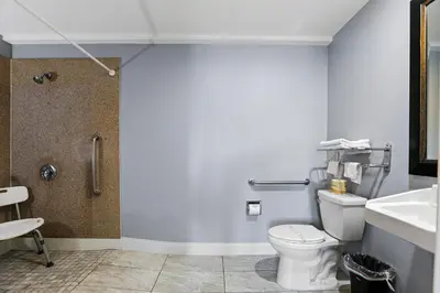 a bathroom with a toilet and a sink and a shower at 3rd Avenue Inn in La Habra