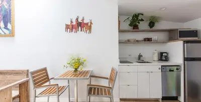 a kitchen with a table and chairs and a refrigerator at Su Casa at Venice Beach in Los Angeles