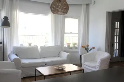 a living room with two white couches and a table at Su Casa at Venice Beach in Los Angeles