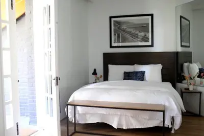 a bedroom with a large bed with a wooden headboard at Su Casa at Venice Beach in Los Angeles