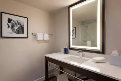 a bathroom with a sink and a mirror at Four Points by Sheraton Bakersfield in Bakersfield