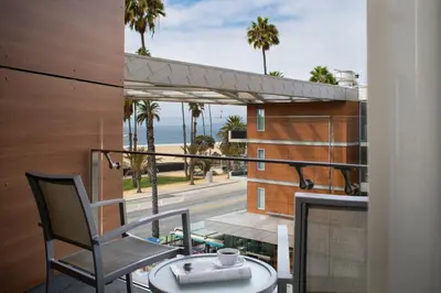 a balcony with a table and chairs and a view of the ocean at Shore Hotel in Los Angeles