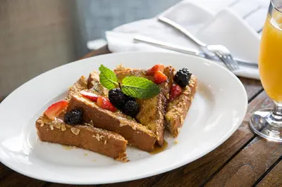 a white plate with two pieces of waffles with fruit at Shore Hotel in Los Angeles