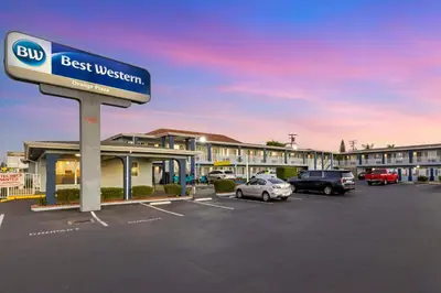 a best western sign in front of a parking lot at Best Western Orange Plaza in Orange