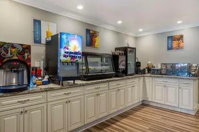 a kitchen with a counter with a popcorn machine at Best Western Orange Plaza in Orange