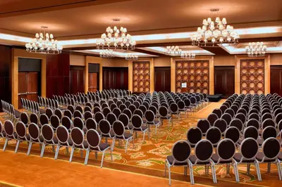 an empty room with chairs and chandeliers at Sheraton Garden Grove-Anaheim South in Anaheim