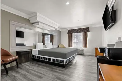 a hotel room with a bed and a television at Rodeway Inn Santa Ana - Garden Grove in Santa Ana