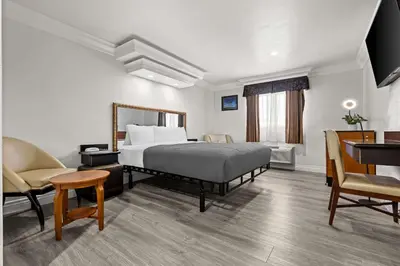 a hotel room with a bed and a desk at Rodeway Inn Santa Ana - Garden Grove in Santa Ana
