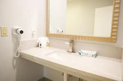 a bathroom with a sink and a mirror at Days Inn by Wyndham West Covina in West Covina
