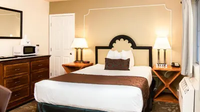 a hotel room with a bed and a television at Americas Best Value Inn Rancho Palos Verdes in Rancho Palos Verdes