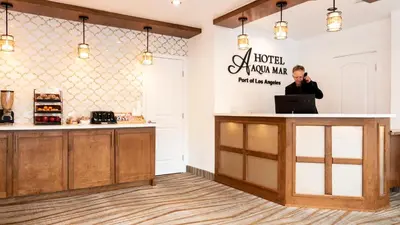 a man talking on a cell phone at a hotel newnan mana restaurant at Americas Best Value Inn Rancho Palos Verdes in Rancho Palos Verdes