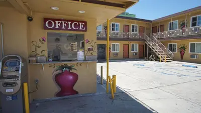 an office building with a vase on the side of it at Rosa Bell Motel - Los Angeles in Los Angeles