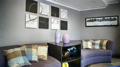 a living room with a couch and a table at Best Western PLUS Avita Suites in Torrance