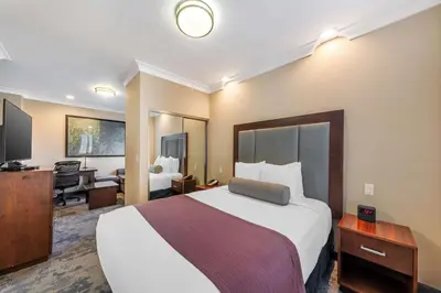 a hotel room with a large bed and a desk at Best Western PLUS Avita Suites in Torrance