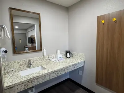 a bathroom with a sink and a mirror at Days Inn by Wyndham Barstow in Barstow