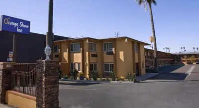 a building with a street sign in front of it at Orange Show Inn in San Bernardino