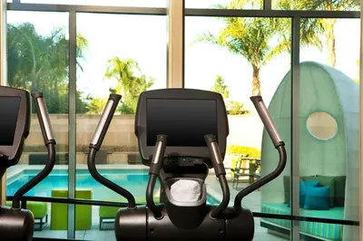 a gym with a swimming pool in the background at Aloft Ontario-Rancho Cucamonga in Rancho Cucamonga