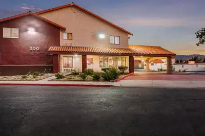 a house on a street with a building at Red Roof Inn Palmdale - Lancaster in Palmdale