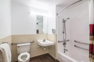 a bathroom with a toilet and a sink and a shower at Red Roof Inn Palmdale - Lancaster in Palmdale