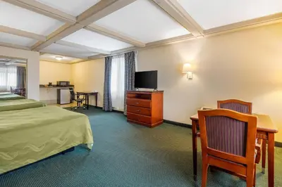 a hotel room with a bed and a desk and a tv at Quality Inn - Torrance Lomita in Lomita