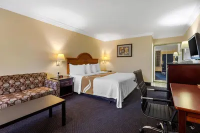 a hotel room with a bed and a couch at Quality Inn - Torrance Lomita in Lomita