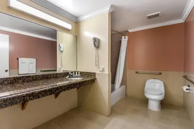 a bathroom with a toilet and a phone at Quality Inn - Torrance Lomita in Lomita