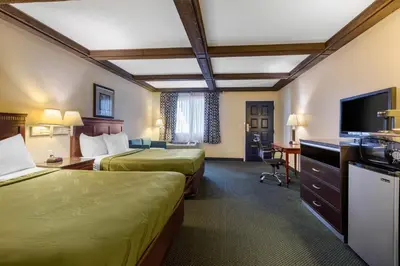 a hotel room with two beds and a flat screen tv at Quality Inn - Torrance Lomita in Lomita