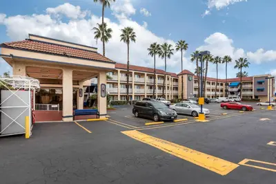 a parking lot with cars parked in front of a hotel at Quality Inn - Torrance Lomita in Lomita