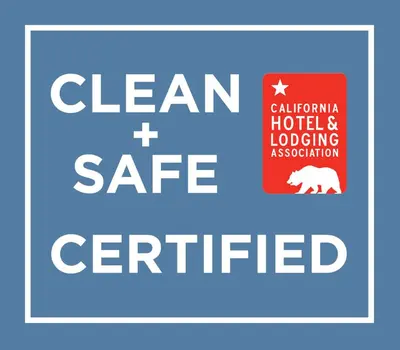 a sign with the words clean and safe certified at Wilshire Motel in Los Angeles