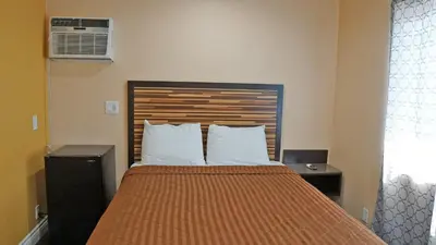 a bedroom with a large bed with white pillows at Holly Crest Hotel - Los Angeles, LAX Airport in Inglewood