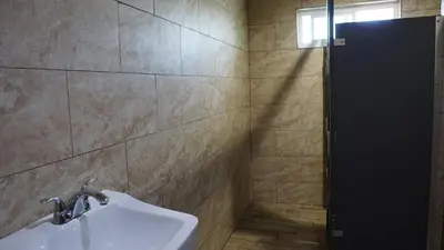 a bathroom with a sink and a shower at Holly Crest Hotel - Los Angeles, LAX Airport in Inglewood