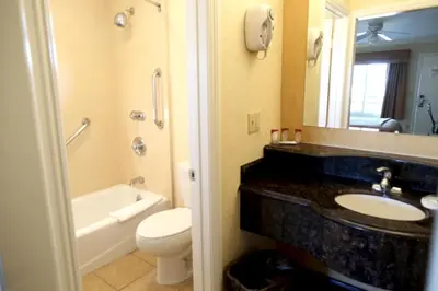 a bathroom with a sink and a toilet and a mirror at Princess Inn in Westminster