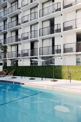 a swimming pool in front of a building at Glendale Express Hotel Los Angeles in Glendale