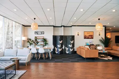 a lobby with couches and a table and chairs at Glendale Express Hotel Los Angeles in Glendale