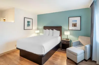 a hotel room with a bed and a chair at Best Western At Ventura Pier in Ventura