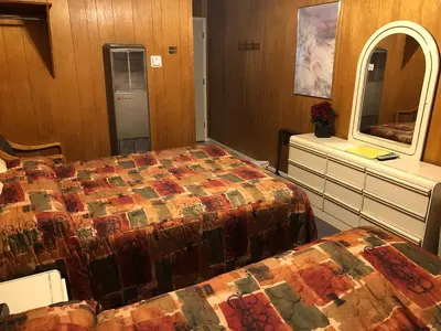 a hotel room with two beds and a mirror at Giant Oaks Lodge in Running Springs