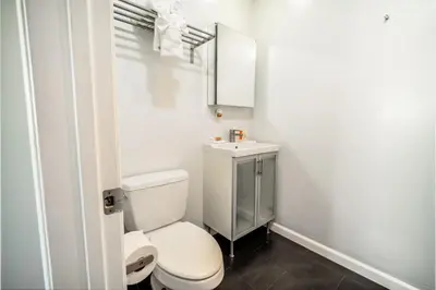 a bathroom with a white toilet and a sink at AIR Venice on the Beach in Los Angeles